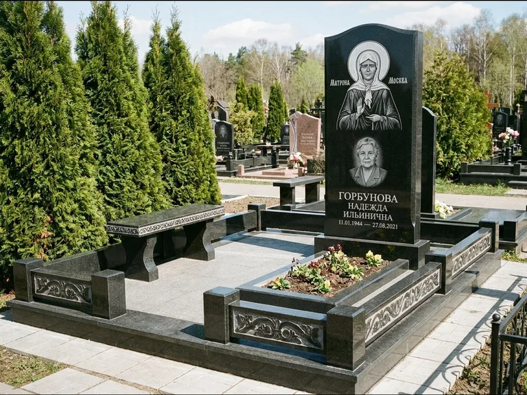 Памятник с гравировкой иконы: стела в форме раскрытой книги с образом — гравировка образа Спасителя, цоколь тёмной плиткой, работа «Зотов» в Норильске