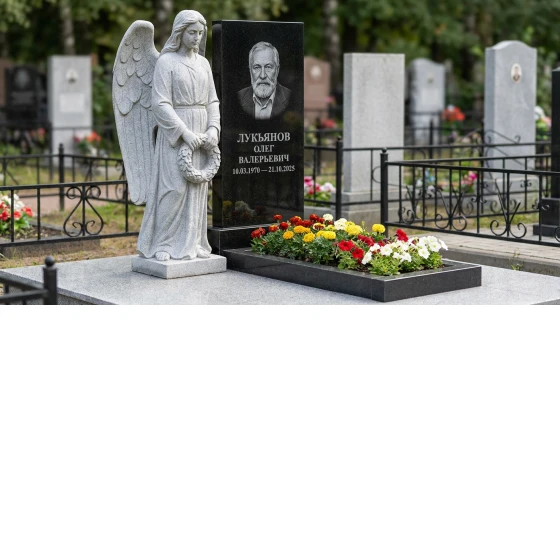 Гранитный памятник в виде раскрытой книги с цветником